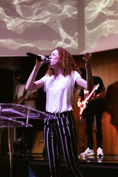 Worship Leader Female Singing with Microphone - Voice in Ministry